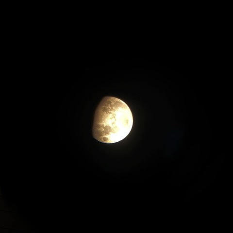 The full moon on Nov. 8, as captured in a photograph through a telescope eyepiece, during the moonwalk.